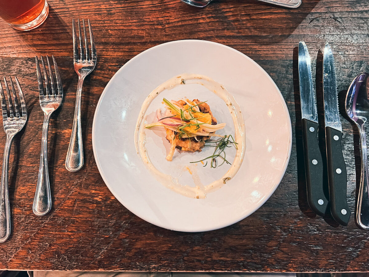 A plated appetizer on a rustic wooden bistro table